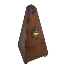 Load image into Gallery viewer, Classic obelisk shaped antique mahogany cased Metronome with brass fittings. Designed and patented by Maëlzel and manufactured by Paquet, France, early 20th century. Serial number 353.455. The brass plate on the cover reads, Paris, France, Angleterre, Amérique, Hollande, Belgique. Remove the cover to reveal the steel timing arm and tempo scale against a dark stained background.
