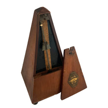 Load image into Gallery viewer, The unique bell chime on this metronome is a feature you can use to signal the start of a measure that has either 2, 3, 4, or 6 beats per measure. The bell can also be set to not strike at all, so it functions as regular metronome. A useful but rare option not normally seen on metronomes.

In good condition with wear to the body commensurate with age. In good working order.

Measures 4 3/8 x 4 3/8 x 9 inches
