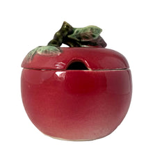 Load image into Gallery viewer, Vintage mid-century era hand painted majolica-style figural ceramic red apple condiment jar featuring handle branch in brown with green leaves. Crafted by Metroware, Japan, 1940s. This sweet apple is perfect for adding a touch of kitsch to your kitchen and table decor!

In vintage condition, no chips, cracks or repairs. Age-related crazing.

Measures 3 7/8 x 4 inches
