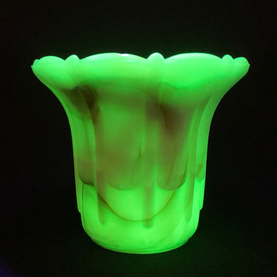 Vintage marbleized uranium slag glass flower pot with ribs and flutes in swirled shades of green, brown and orange. Glows intensely under black light. Produced by Akro Agate, circa 1930s. A lovely piece for small plants. Easily repurpose as a catchall, candy dish or upscale your office and use this as a paperclip holder.  In as found vintage condition, there is a small chip at the rim. Marked “Made in U.S.A.”  Measures 3 1/2 x 3 inches