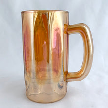 Load image into Gallery viewer, A vintage marigold carnival glass handled beer mug has great iridescence! Crafted by the Jeannette Glass Company, USA, circa 1920s/30s. Enjoy a cold one in this special piece of glass!  In excellent condition, free from chips/cracks.  Measures 3 x 5 1/2-inches tall  Capacity 10 ounces
