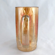 Load image into Gallery viewer, A vintage marigold carnival glass handled beer mug has great iridescence! Crafted by the Jeannette Glass Company, USA, circa 1920s/30s. Enjoy a cold one in this special piece of glass!  In excellent condition, free from chips/cracks.  Measures 3 x 5 1/2-inches tall  Capacity 10 ounces
