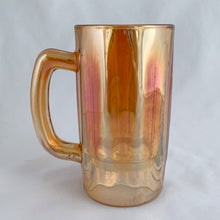 Load image into Gallery viewer, A vintage marigold carnival glass handled beer mug has great iridescence! Crafted by the Jeannette Glass Company, USA, circa 1920s/30s. Enjoy a cold one in this special piece of glass!  In excellent condition, free from chips/cracks.  Measures 3 x 5 1/2-inches tall  Capacity 10 ounces
