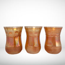 Load image into Gallery viewer, Vintage marigold carnival glass Maharajah corset-shaped shot glass. Crafted by Jain Glassworks, India, 1930s. The iridescence, pattern and shape are lovely on this rare piece of glass!

In excellent vintage condition, no chips.

Measures 1 7/8 x 2 3/4 inches
