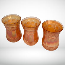 Load image into Gallery viewer, Vintage marigold carnival glass Maharajah corset-shaped shot glass. Crafted by Jain Glassworks, India, 1930s. The iridescence, pattern and shape are lovely on this rare piece of glass!

In excellent vintage condition, no chips.

Measures 1 7/8 x 2 3/4 inches
