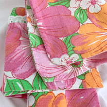 Load image into Gallery viewer, This is a gorgeous pillowcase in the &quot;Martinique&quot; pattern in the pink/orange/green colourway with a lovely white eyelet detail at the hem in 100% cotton. Produced by Wabasso Canada, circa 1970s. This colourful mod flower power print brings so much fun and energy to your home decor!  This pillow case is in excellent vintage condition, free from fading/tears. The colours are vibrant. Original label present.   Measures 20 x 34 inches
