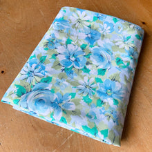 Load image into Gallery viewer, Vintage Marvelaire Moon Flower flat double bed sheet featuring a flower power design in shades of blue, green, white and black. 50% polyester / 50% cotton. Crafted by Springmaid, USA, 1970 - 1972s. A beautiful addition to your retro bedding decor, or repurpose for crafting.

In excellent vintage condition, no stains/tears. Colours are vibrant.

Measures 79 x 98 inches
