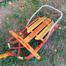 Load image into Gallery viewer, Classic vintage mid-century Mastercraft children&#39;s snow sled. The model is No. 570100. This sled features a steel frame with wood skis, deck and steering bar, metal backrest and mattress cushion. Crafted by Canadian Tire Corporation, Canada, 1960s. Bring back all the wonderful of snowy winter days with this beloved wee sled!

In as found vintage condition with wear to the entire piece commensurate with use and age. Original sticker present.
