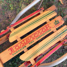 Load image into Gallery viewer, Classic vintage mid-century Mastercraft children&#39;s snow sled. The model is No. 570100. This sled features a steel frame with wood skis, deck and steering bar, metal backrest and mattress cushion. Crafted by Canadian Tire Corporation, Canada, 1960s. Bring back all the wonderful of snowy winter days with this beloved wee sled!

In as found vintage condition with wear to the entire piece commensurate with use and age. Original sticker present.
