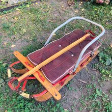 Load image into Gallery viewer, Classic vintage mid-century Mastercraft children&#39;s snow sled. The model is No. 570100. This sled features a steel frame with wood skis, deck and steering bar, metal backrest and mattress cushion. Crafted by Canadian Tire Corporation, Canada, 1960s. Bring back all the wonderful of snowy winter days with this beloved wee sled!

In as found vintage condition with wear to the entire piece commensurate with use and age. Original sticker present.
