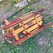 Load image into Gallery viewer, Classic vintage mid-century Mastercraft children&#39;s snow sled. The model is No. 570100. This sled features a steel frame with wood skis, deck and steering bar, metal backrest and mattress cushion. Crafted by Canadian Tire Corporation, Canada, 1960s. Bring back all the wonderful of snowy winter days with this beloved wee sled!

In as found vintage condition with wear to the entire piece commensurate with use and age. Original sticker present.
