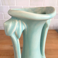 Load image into Gallery viewer, Beautiful vintage Art Deco matte aqua leaf topped handled vase. Crafted by McCoy Pottery, 1940s. This vase is must for any art pottery collector!

In as found vintage condition, area at the rim where glaze has come away, no chips/cracks/repairs. Maker&#39;s mark on the bottom.

Measures 5 1/4 x 9 1/4 inches
