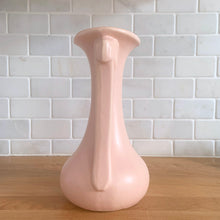 Load image into Gallery viewer, Beautiful vintage Art Deco matte pink leaf topped handled vase. Crafted by McCoy Pottery, 1940s. This vase is must for any art pottery collector!

In excellent vintage condition, no chips, no cracks, no repairs. Maker&#39;s mark on the bottom.

Measures 5 1/4 x 9 1/4 inches
