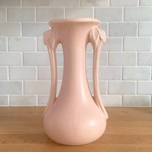 Load image into Gallery viewer, Beautiful vintage Art Deco matte pink leaf topped handled vase. Crafted by McCoy Pottery, 1940s. This vase is must for any art pottery collector!

In excellent vintage condition, no chips, no cracks, no repairs. Maker&#39;s mark on the bottom.

Measures 5 1/4 x 9 1/4 inches
