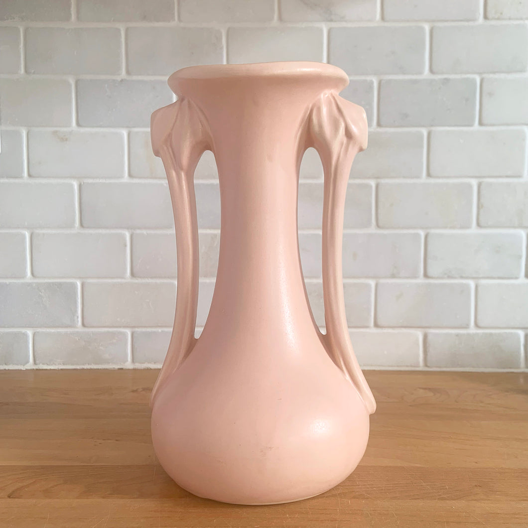 Beautiful vintage Art Deco matte pink leaf topped handled vase. Crafted by McCoy Pottery, 1940s. This vase is must for any art pottery collector!

In excellent vintage condition, no chips, no cracks, no repairs. Maker's mark on the bottom.

Measures 5 1/4 x 9 1/4 inches