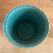 Load image into Gallery viewer, Vintage art deco matte teal ceramic jardiniere planter featuring repeating columns of stacked palm leaves atop a basket weave pattern. Crafted by Robinson Ransbottom Pottery Co., USA, 1930s. A beautiful piece to add to your art pottery collection!

In excellent condition, no chips/cracks/repairs. Typical manufacturing glaze pops. Marked 112/-.

Measures 7 x 5 1/2 inches
