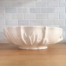 Load image into Gallery viewer, Vintage Art Deco large matte white glazed lotus centrepiece console bowl. Crafted by Nelson McCoy Pottery, 1940s. This rare piece is must for any Nelson McCoy art pottery collector!

In good vintage condition, minor flea bite on the inner edge, no cracks or repairs. Typical manufacturers glaze bubbles. Maker&#39;s mark.

Measures 12 x 7 1/2 x 4 inches

