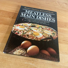 Load image into Gallery viewer, Better Homes and Gardens is known for its fabulous cookbooks. This hardcover cookbook focuses on Meatless Main Dishes inspired recipes. Its 96 pages are filled with amazing  recipes along with many colour photographs. Originally published by Meredith Corporation, USA, 1981. This is the third printing, 1982.   In great vintage condition with normal age-related yellowing.
