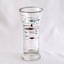 Load image into Gallery viewer, This vintage mid-century &quot;Mediterranean&quot; flat tumbler glass is covered in  aqua and platinum atomic style fish, plus a platinum rim. Crafted by the Libbey Glass Company, circa 1950s.   Measures 2 1/8 x 4 3/8 inches  Capacity 3 ounces
