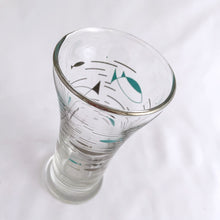 Load image into Gallery viewer, This vintage mid-century &quot;Mediterranean&quot; flat tumbler glass is covered in  aqua and platinum atomic style fish, plus a platinum rim. Crafted by the Libbey Glass Company, circa 1950s.   Measures 2 1/8 x 4 3/8 inches  Capacity 3 ounces
