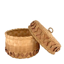 Load image into Gallery viewer, Side view of the antique Mi'kmaq Wabanaki fancy basket with lid askew, showing the full height profile, jikiji'j curl band, plain woven body, and sweetgrass loop handle, early 20th century
