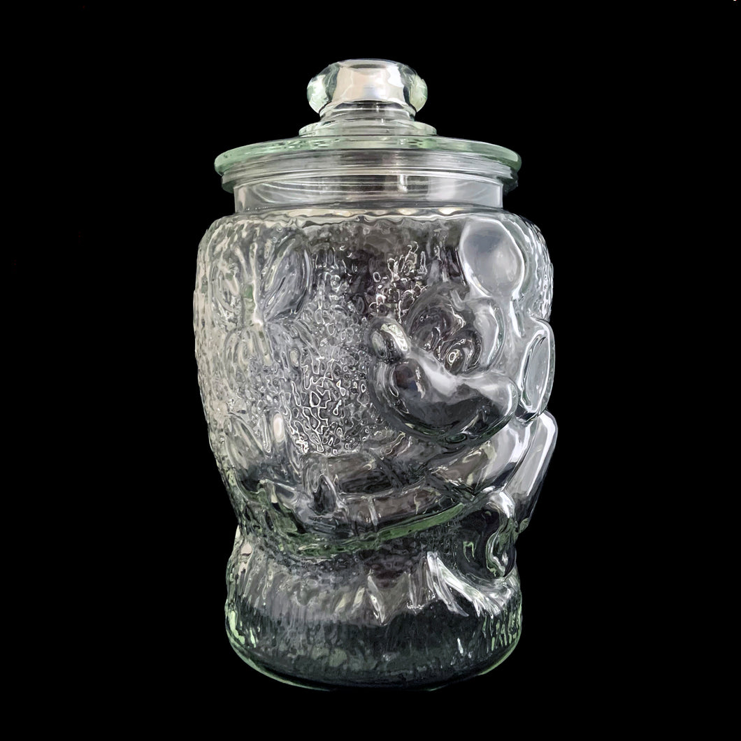 Super fun, vintage embossed Mickey Mouse clear glass lidded jar. Perfect for cookies and dry goods storage. Whether you're a collector or just a Walt Disney fan, this canister is a must-have!  In excellent condition, free from chips. Note there is a rough mold release on one side of the lid seam.  Measures 7 1/2 x 12 13/4 inches