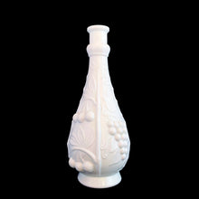 Load image into Gallery viewer, Vintage milk glass genie bottle featuring an embossed pattern of cherries and grapevines. Produced by glass artisans in the Empoli region of Italy. This superb mid-century piece of art glass would make a unique addition to your home decor collection. Perfect as a decanter, vase or decor piece. Dates between 1950 to 1970. These bottles are incredibly fabulous and highly collectible.

In excellent vintage condition, no chips. Unmarked. No stopper.

Measures 4 x 10 1/2 inches
