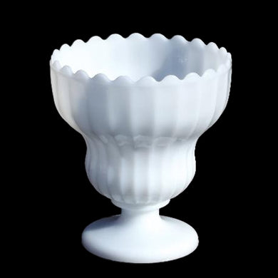 This elegant and substantially sized vintage milk glass planter features a tiered feminine fluted body with a smooth scalloped edge atop a round pedestal. Crafted by EO Brody, USA, 1950s. The perfect vessel for greenery, flowering plants or to safekeep a bridal bouquet. Ideal cottage, farmhouse, shabby chic or wedding decor.

In excellent condition, no chips.

Measures 7 x 8 inches
