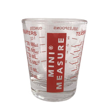 Load image into Gallery viewer, Clear shot glass featuring Mini Measure© logo and measures printed in red. Crafted by Libbey Glass, USA.  In good condition, no chips, wear to the paint, no dishwasher damage.  Measures 2 x 2 1/4 inches  Capacity 1 ounce
