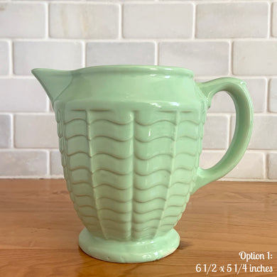Vintage glossy mint green ceramic pitcher 308 which has an exterior pattern of horizontal waves. Crafted by Robinson Ransbottom Pottery Co., USA, 1930s. A lovely piece to add to your art pottery tableware collection which can be used as intended or fill with flowers!

In as found vintage condition, small chip to the foot, no cracks/repairs. Maker's marks.

Option 1: measures 6 1/2 x 5 1/4 inches (incl. handle/spout)