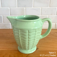 Load image into Gallery viewer, Vintage glossy mint green ceramic pitcher 308 which has an exterior pattern of horizontal waves. Crafted by Robinson Ransbottom Pottery Co., USA, 1930s. A lovely piece to add to your art pottery tableware collection which can be used as intended or fill with flowers!

In as found vintage condition, small chip to the foot, no cracks/repairs. Maker&#39;s marks.

Option 1: measures 6 1/2 x 5 1/4 inches (incl. handle/spout)
