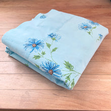 Load image into Gallery viewer, Dress your bed with this vintage twin size &#39;Miracle&#39; flat sheet featuring a lovely pattern of blue, orange and green flower pattern on baby blue. Cotton/Poly blend. Manufactured by Pacific, USA, circa 1970s. Create a restful slumber with this beautifully designed, high quality textile, or repurpose for crafting or sewing projects!  In excellent condition, free from stains/tears. Colours are vibrant.  Measures 72 x 104 inches
