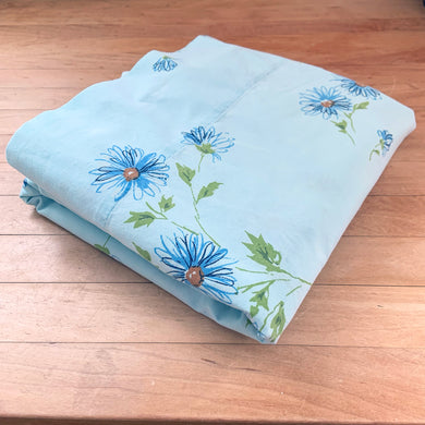 Dress your bed with this vintage twin size 'Miracle' flat sheet featuring a lovely pattern of blue, orange and green flower pattern on baby blue. Cotton/Poly blend. Manufactured by Pacific, USA, circa 1970s. Create a restful slumber with this beautifully designed, high quality textile, or repurpose for crafting or sewing projects!  In excellent condition, free from stains/tears. Colours are vibrant.  Measures 72 x 104 inches
