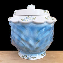 Load image into Gallery viewer, Adorable vintage hand painted Miss Priss anthropomorphic blue kitty cat head ceramic cookie jar. Lefton, Japan, 1950s. Highly sought after, this sweet cookie jar represents the epitome of collectible kitsch kitchen decor!

The vessel is in excellent condition, no chips/cracks/repairs. The lid has a repair to the top and several chips with one to the back of the flower, none detract from display or function, please see photos for details.

Measures 7 1/2 x 6 x 7 1/2 inches
