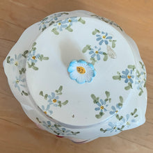 Load image into Gallery viewer, Adorable vintage hand painted Miss Priss anthropomorphic blue kitty cat head ceramic cookie jar. Lefton, Japan, 1950s. Highly sought after, this sweet cookie jar represents the epitome of collectible kitsch kitchen decor!

The vessel is in excellent condition, no chips/cracks/repairs. The lid has a repair to the top and several chips with one to the back of the flower, none detract from display or function, please see photos for details.

Measures 7 1/2 x 6 x 7 1/2 inches
