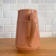 Load image into Gallery viewer, Vintage gloss mocha glazed ceramic tapered pitcher with horizontal bands. Crafted by Donvale Vitrified China, Canada, early 20th century. Restaurant ware nicely complements any farmhouse and cottage kitchen or use as a vase.

In as found vintage condition, glaze pops and chipping at the rim, no cracks/repairs. Unmarked.

Measures 5 3/4 x 6 1/8 inches including handle/spout, mouth 3 inches
