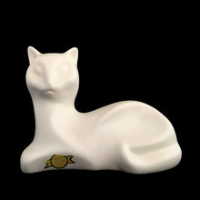 Load image into Gallery viewer, A striking example of vintage MCM craftsmanship, this matte cream art pottery cat embodies the minimalist aesthetic that defined 1960s modernism with its geometric lines and understated elegance. Crafted by the acclaimed Laurentian Pottery studio in Québec, Canada. Its sculptural form and subtle finish have earned it recognition among serious collectors of MCM design and Canadian ceramics, making it a coveted addition to curated collections.

Excellent condition, no chips/cracks/repairs. Original sticker.
