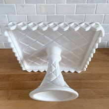 Load image into Gallery viewer, Angled view of the underside of Indiana Glass Monterey milk glass square pedestal cake stand showing diamond pattern on the pedestal, rim and underside
