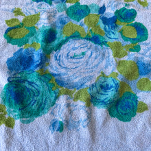 Load image into Gallery viewer, Vintage Monticello 100% cotton blue terry cloth hand towel featuring a pattern of blue, teal and green flowers with fringe edges. Crafted by Cannon Mills, USA, circa 1970s.  In excellent used condition, free from stains/tears. Measures 16 x 28 inches
