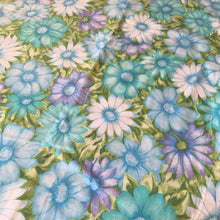 Load image into Gallery viewer, Vintage Monticello Celestial Blue Aloha twin flat bed sheet featuring a&nbsp;tropical all-over print of flowers in shades of blue, turquoise, green and purple. Crafted by Cannon, USA, 1972 – 1975. The vibrant textile is perfect for adding a touch of island flower power to your bed linens or repurpose for crafting or dressmaking.

In excellent like-new condition, no stains/tears. Original tag.

Measures 72 x 98 inches
