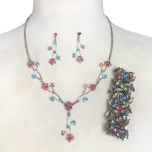 Load image into Gallery viewer, Floral necklace with matching stud drop pierced style earrings and stretch bracelet featuring rhinestone crystals in pink, aurora borealis, light blue, peridot green and yellow. Silver-toned imitation platium plated findings and the earring posts are made with sterling silver.

In excellent condition.
