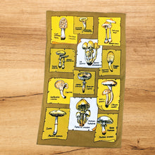 Load image into Gallery viewer, Vintage cotton tea towel featuring a variety of mushroom with their common and Latin names. The colours of olive green, green, yellow and black are vibrant. This towel will adds tons of retro charm to your kitchen decor! In excellent condition. Measures 17 x 28 inches
