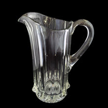 Load image into Gallery viewer, Antique National Glass Co. No. 575 Hercules clear pressed glass pitcher, three-quarter front view showing vertical ribbed body, applied handle, and star-motif base, c. 1904
