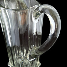 Load image into Gallery viewer, Close-up detail of National Glass Co. Hercules pitcher handle and upper body, showing applied handle attachment, vertical ribs, and pressed floral base motif
