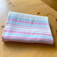 Load image into Gallery viewer, Vintage natural linen tablecloth featuring stripes in light pink, dark pink and blue. Give your table a touch of rustic charm with this grain sack style table covering. Perfect for&nbsp; farmhouse, shabby chic and cottage core decor styles.  In excellent condition, free from stains/tears  Tablecloth measures 59 x 77 inches
