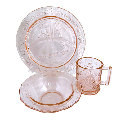 Adorable vintage pink depression glass child's dinnerware set including a plate, bowl and mug featuring nursery rhymes. Crafted by Tiara Indiana Glass, USA, circa 1990s. a beautiful gift for the parent's to be!  In excellent condition, free from chips.