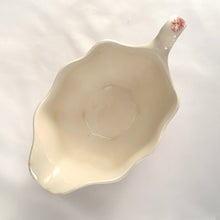 Load image into Gallery viewer, Vintage pink transferware Old Britain Castles creamer. Crafted by Johnson Bros, England, 1930 - 2003. A lovely way to enhance your tea and coffee experience!

In as found condition, inner chip to one of the feet, no cracks or repairs. Maker&#39;s mark on the bottom.

Measures 6 1/4 x 3 5/8 x 2 7/8 inches (incl. handle)

Capacity 8 ounces
