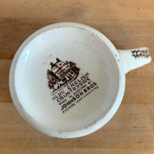 Load image into Gallery viewer, Underside of Johnson Bros Old English Countryside mug showing "Olde English Countryside — Made in England by Johnson Bros — A Genuine Hand Engraving" backstamp with crazing
