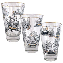 Load image into Gallery viewer, Set of six vintage Old Ships glass tumblers featuring black, white and gold sailing vessels with gold rims. Crafted by Libbey Glass, circa 1950s. A great addition to your barware collection or perfect for the sailing enthusiast!  In excellent condition, no chips, minor wear to the gold rim. Marked on the bottom with the Libbey &quot;L&quot;.  Measures 3 1/2 x 5 1/4 inches  Capacity 12 ounces
