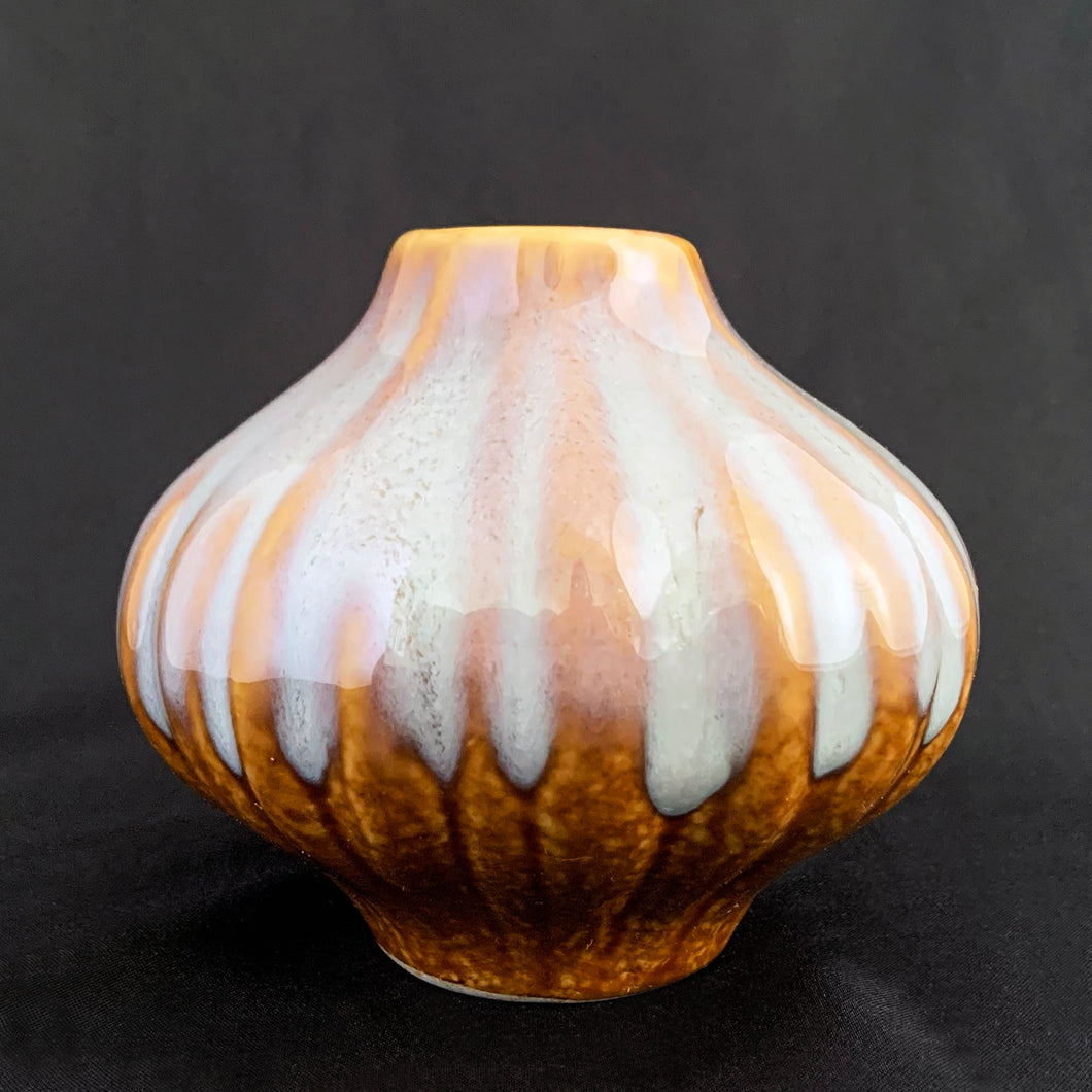 Very cool vintage bulb-shaped bud vase with really nicely done drip glaze. The main colour is a mustard with a cream drip glaze over the top, with hints of purple. Would look great in any room. Perfect for a little floral arrangement, or repurpose as a pen/toothbrush/make-up brush holder.  Circa 1970. Likely made in West Germany.  In excellent condition, no chips, cracks or repairs.  Measures 4 x 3 1/2 inches